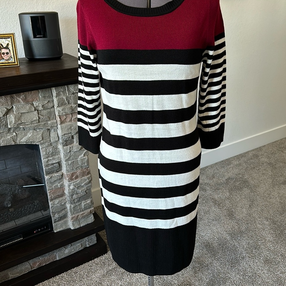 Black and white sweater dress with red accent at top